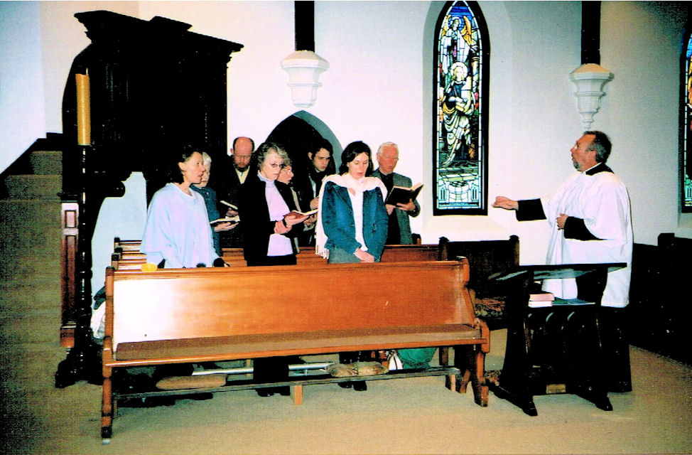 David Hoskins conducts a group of singers shortly after his appointment